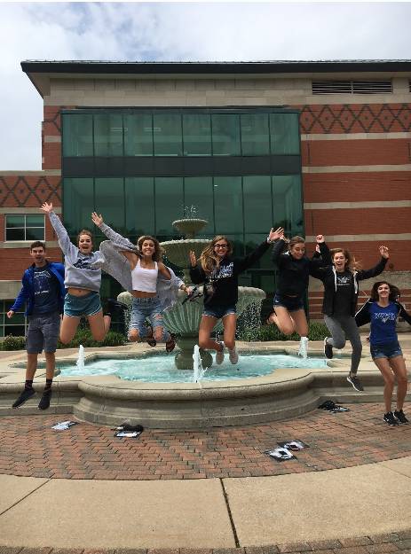 Students jumping in front of a fountain during Welcome Days 2018